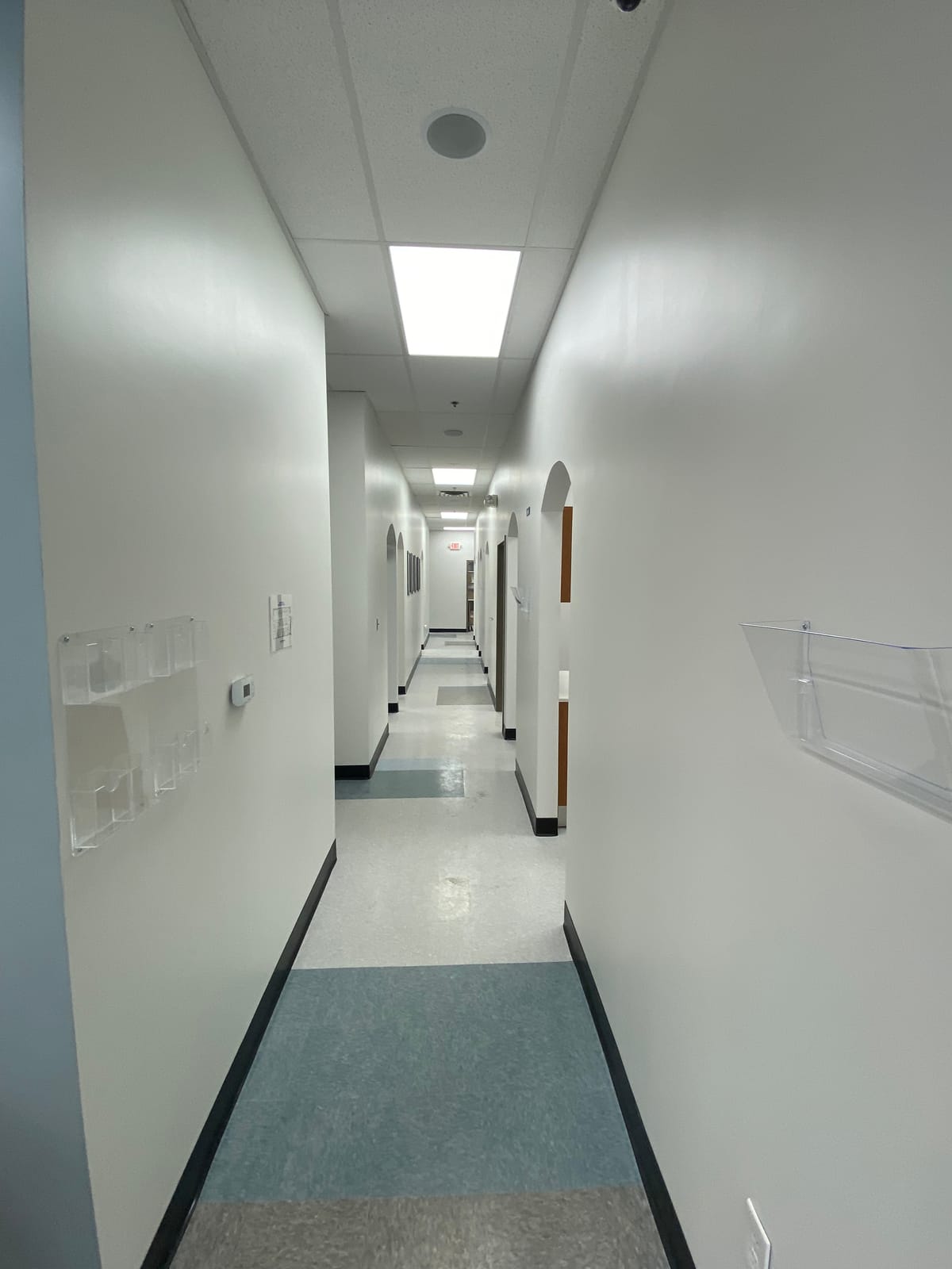 Freshly painted patient hallway with arched doorways at a dental clinic build-out
