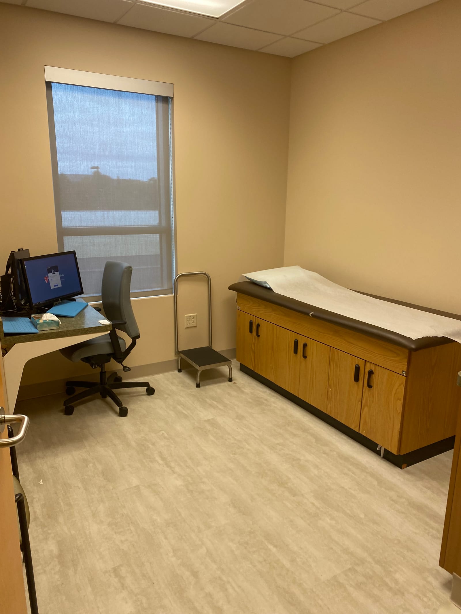 Finished patient examination room at University Hospitals Ahuja Medical Center, repainted walls and ceiling with the original wood casework kept in place