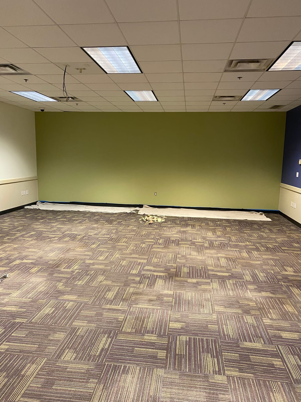 Freshly painted green accent wall in an activity room at Blossom Hill Adult Daycare