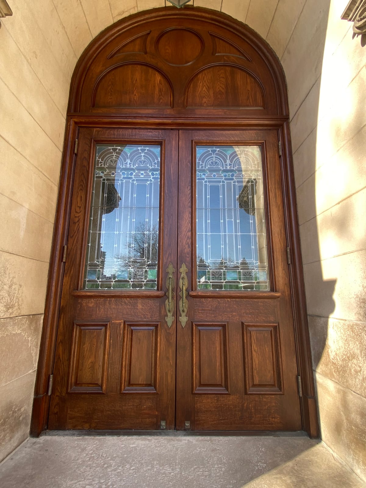 Restored 116-year-old wood entrance doors with stained glass panels