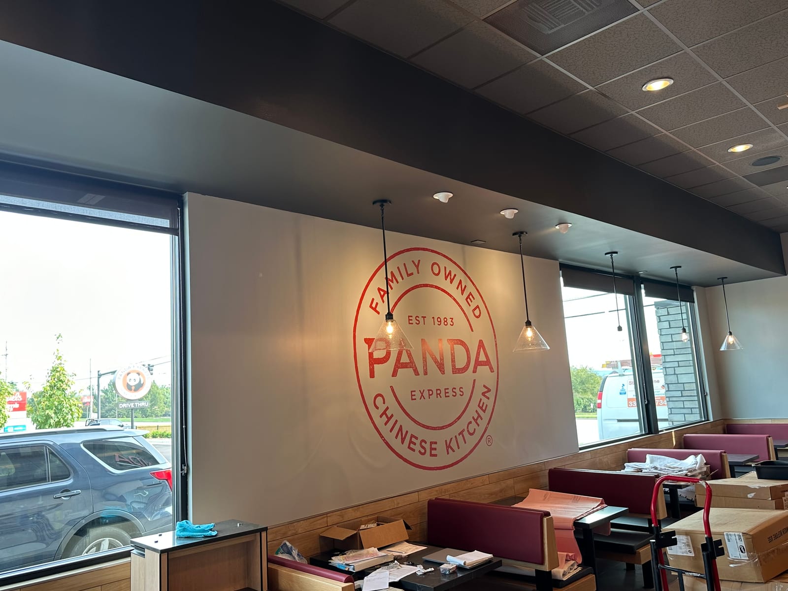 Finished Panda Express dining room, branded logo wall, full-height windows and a clean painted ceiling