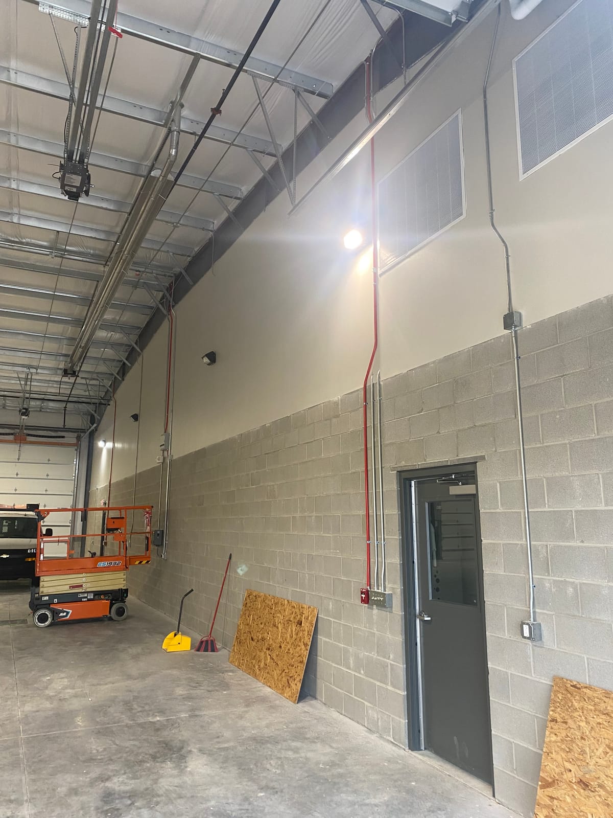 New metal and CMU building exterior with garage door and man door, on a Stark County industrial build