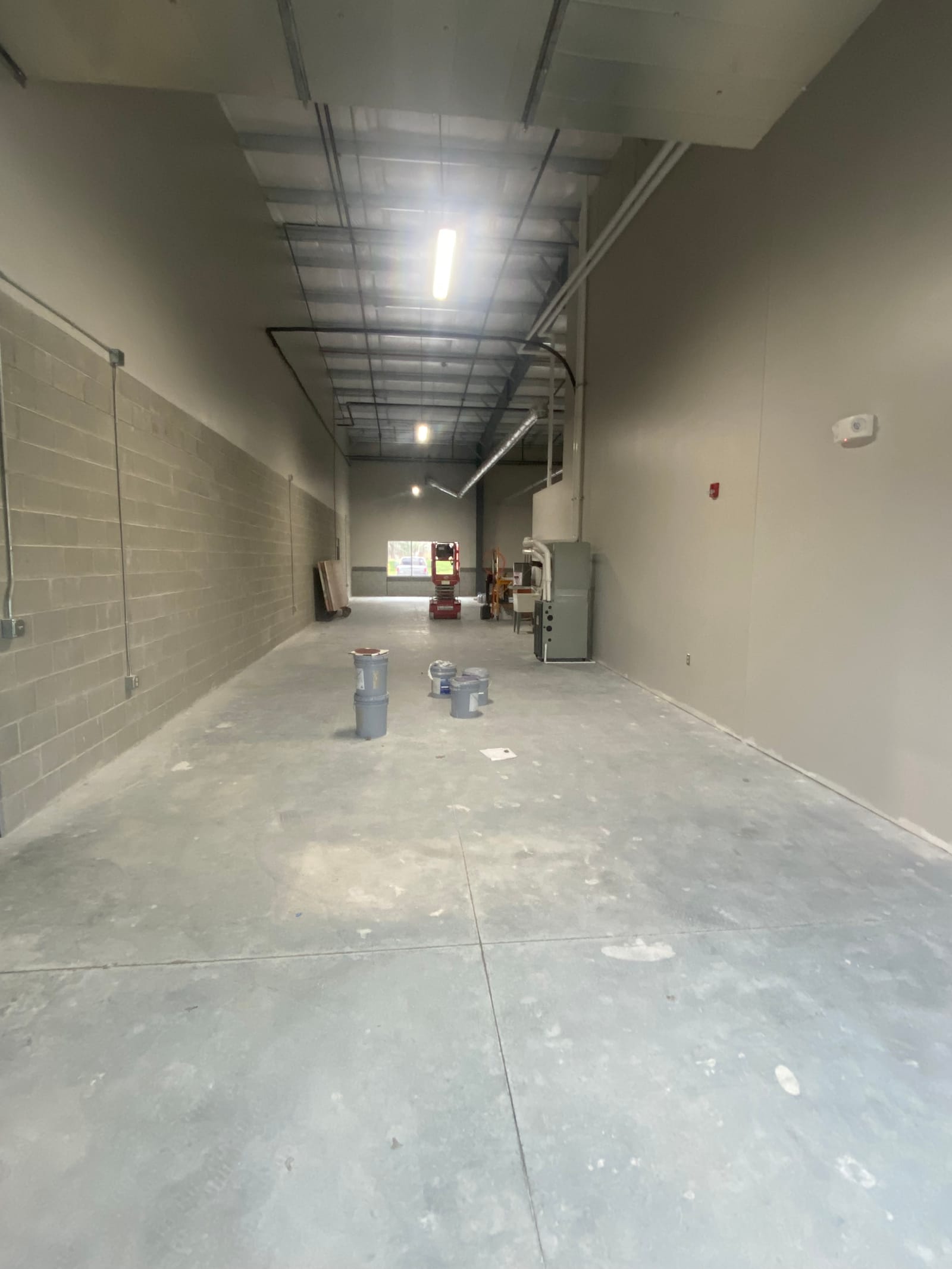 Long finished corridor running to the vanishing point under new ceiling lighting