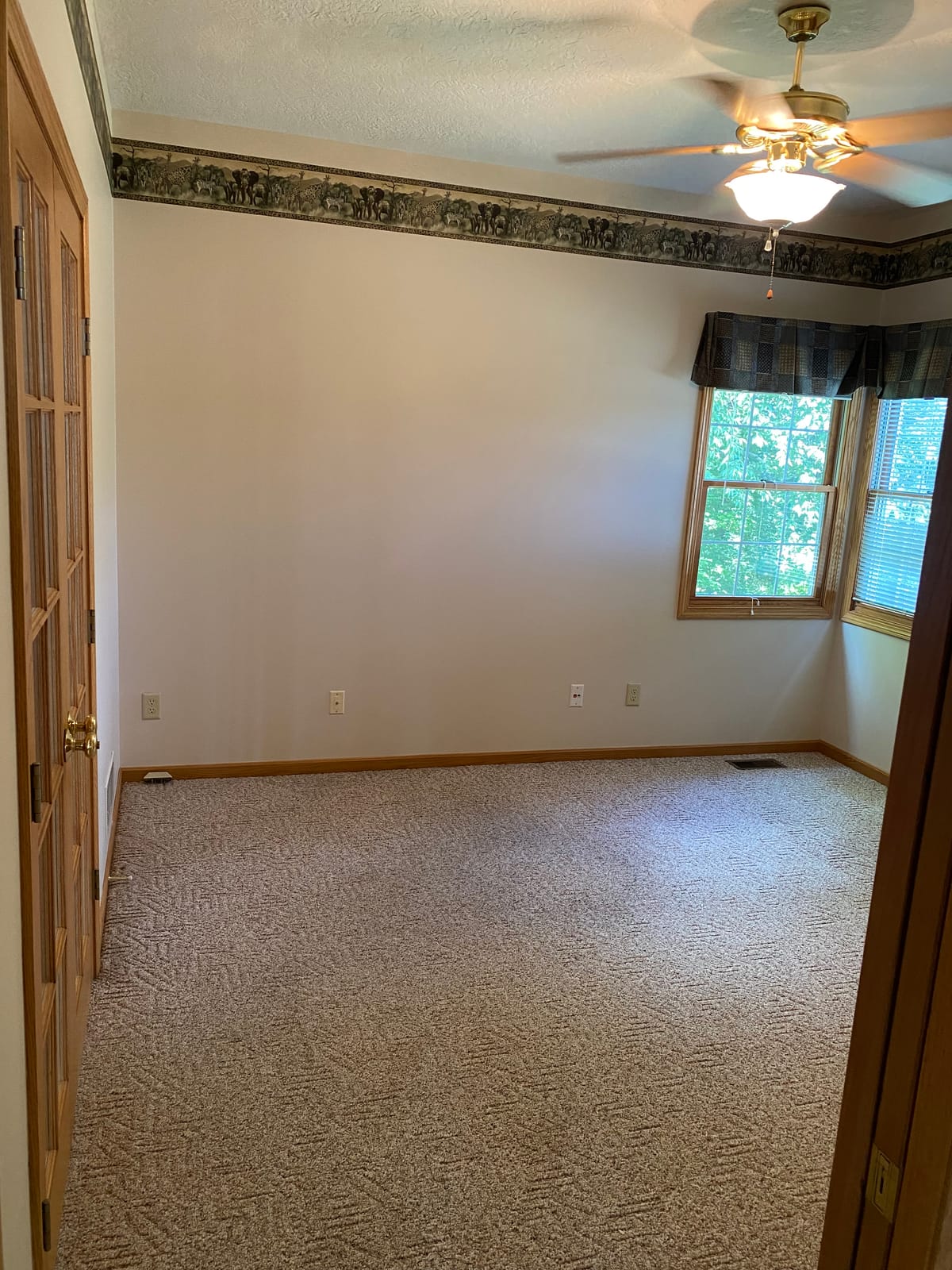 Repainted bedroom trim and walls with a clean neutral coat over a removed wallpaper border in a Northeast Ohio home