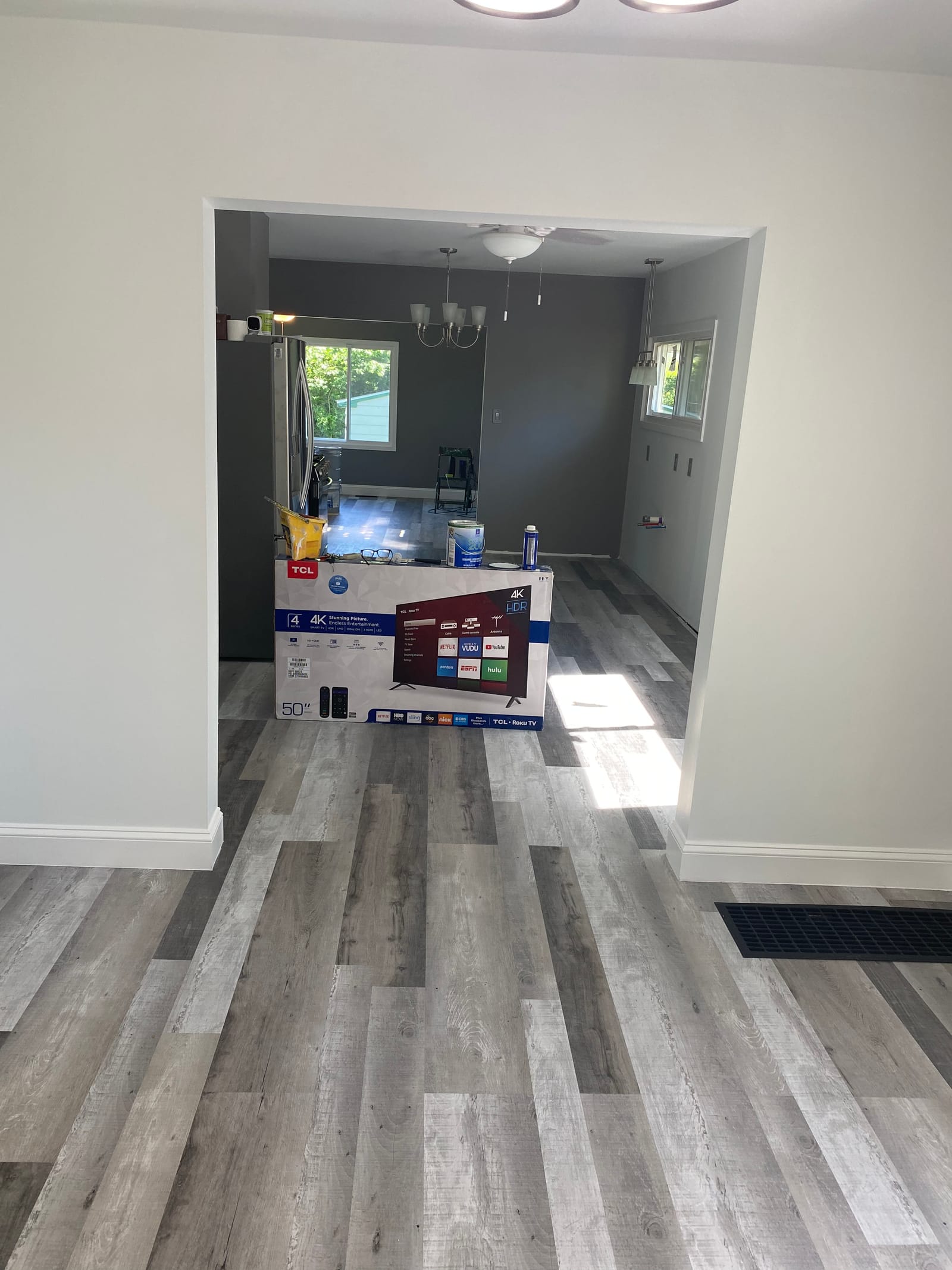 Finished living room interior, plank feature wall, painted fireplace surround and ceiling