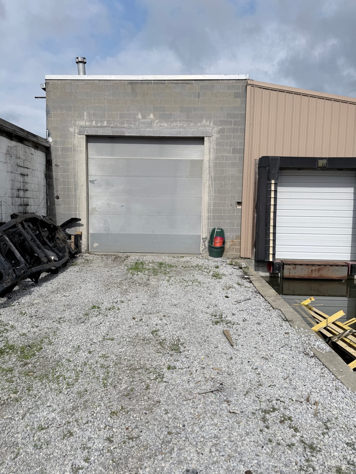 Repainted metal-clad wall section in tan alongside painted CMU block on a Canton Commercial and Industrial building
