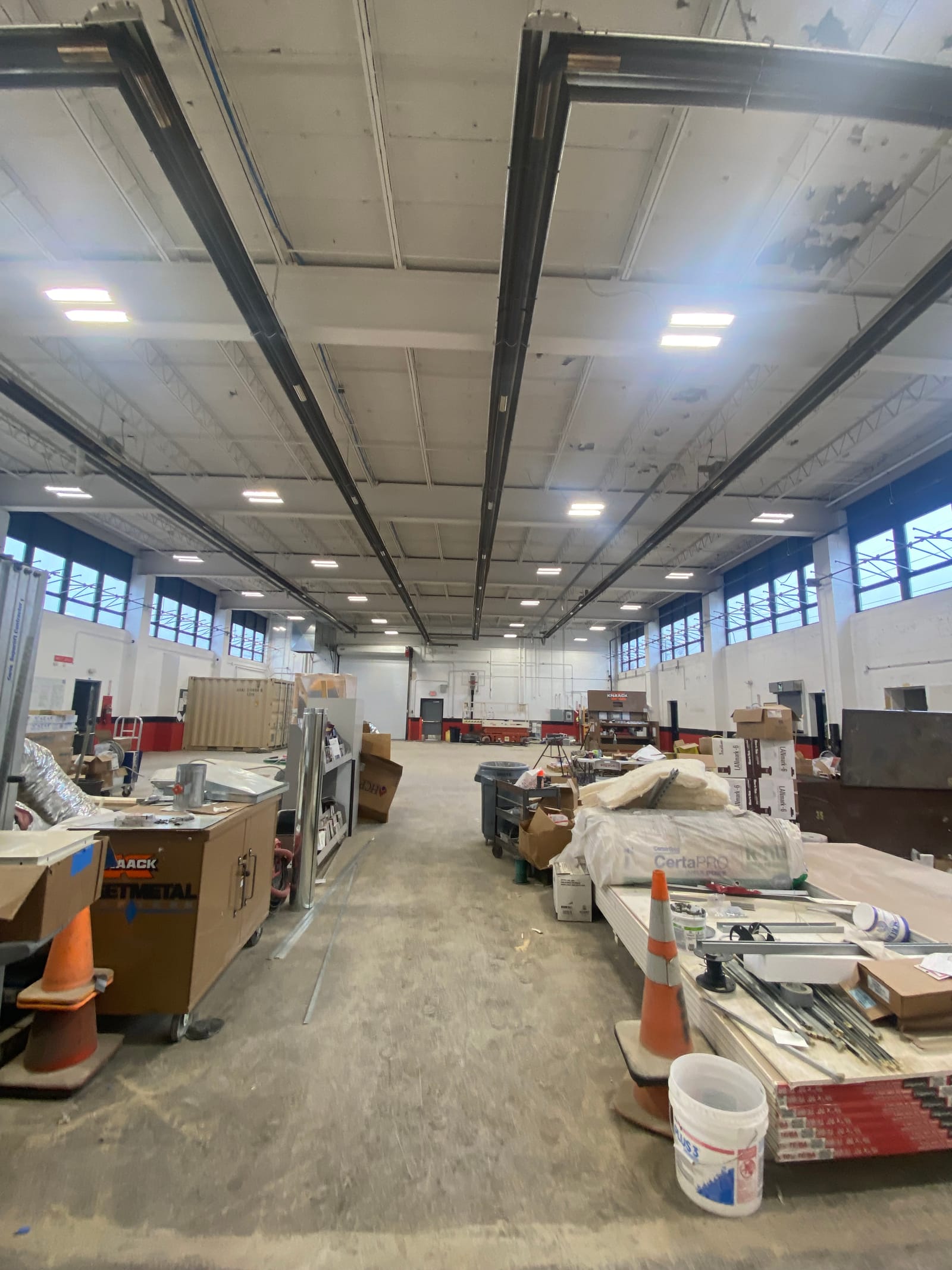 The Wooster Armory drill hall shot wide, tall window bays above a freshly coated full-height elevation